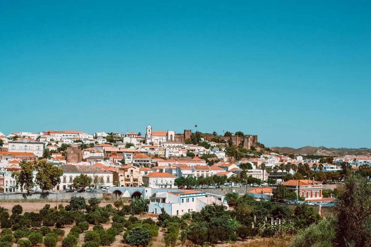 Beautiful panoramic view of Silves in Portugal showcasing historic buildings and Silves Castle under a clear blue sky.