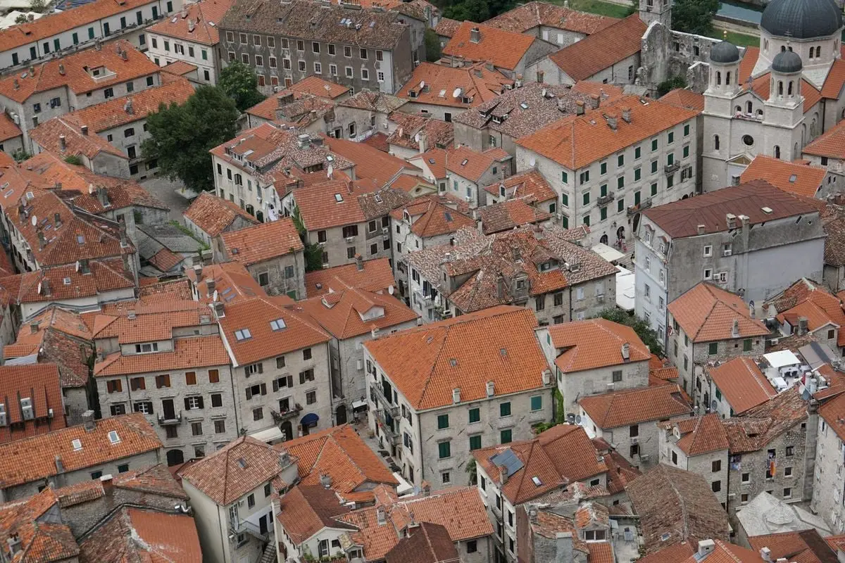Explore the charming red rooftops and historic architecture of Kotor, Montenegro from above.