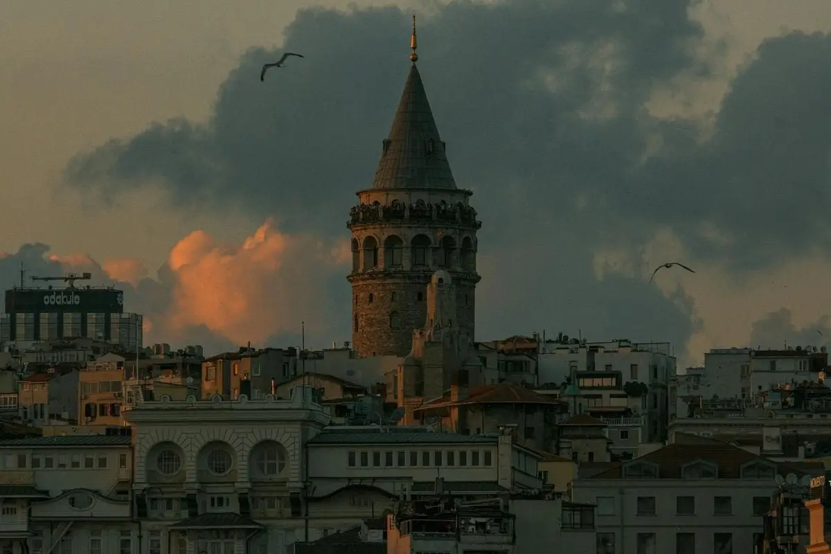 Scenic view of Galata Tower amidst cityscape during sunset in Istanbul.