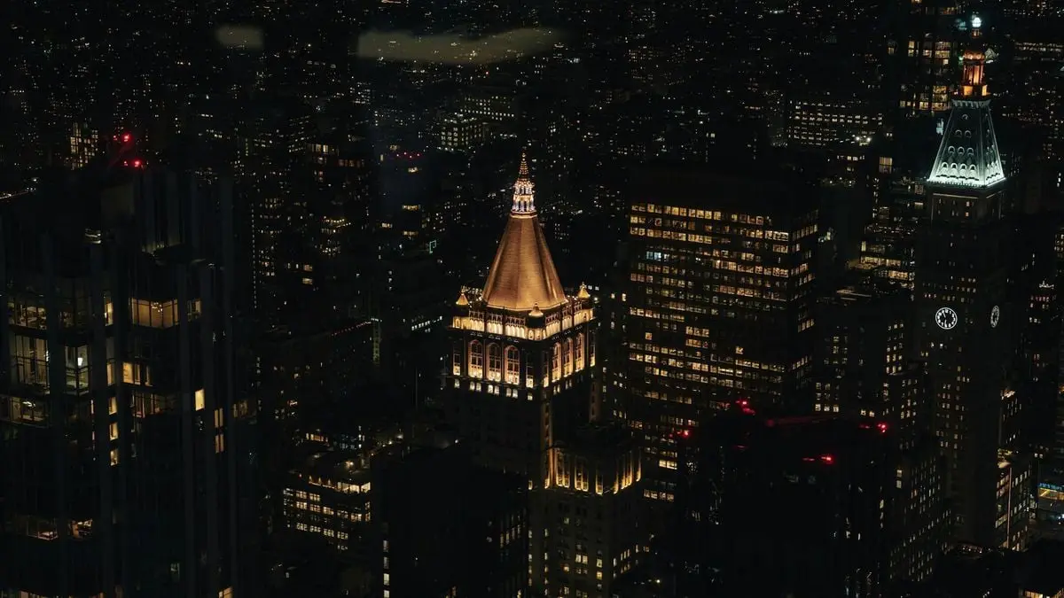 Captivating aerial view of New York City's illuminated skyline at night, showcasing iconic architecture.