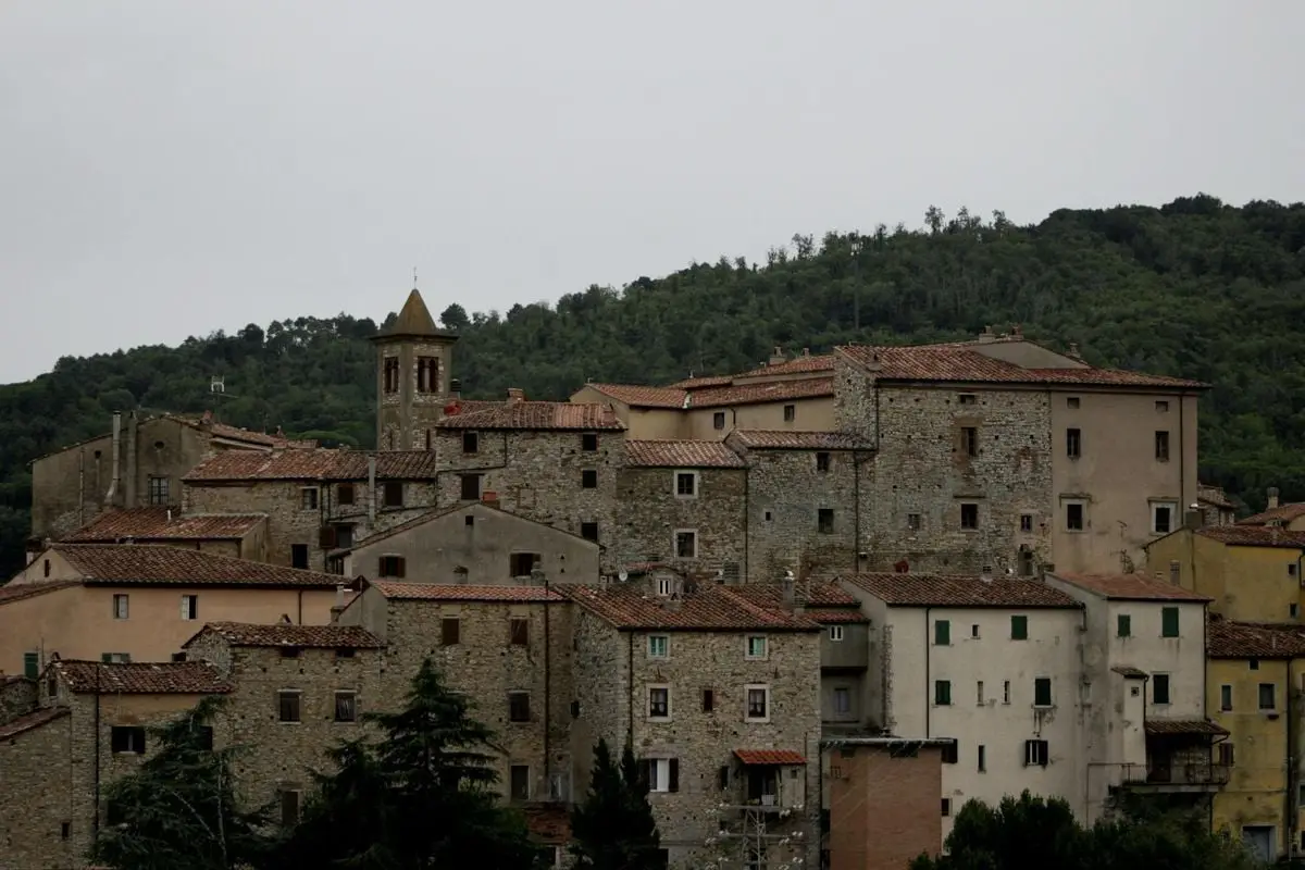 Charming view of historic stone buildings in a Tuscan village setting.