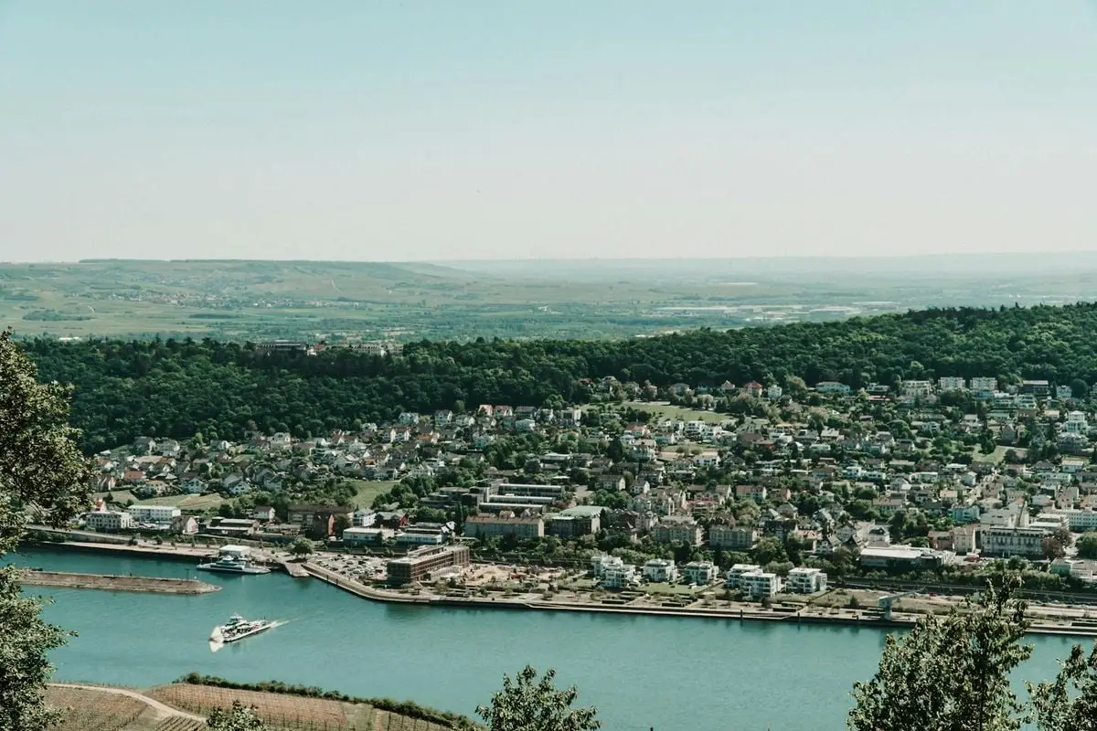A scenic aerial view showcasing the Rhine River and a quaint German town surrounded by lush greenery.