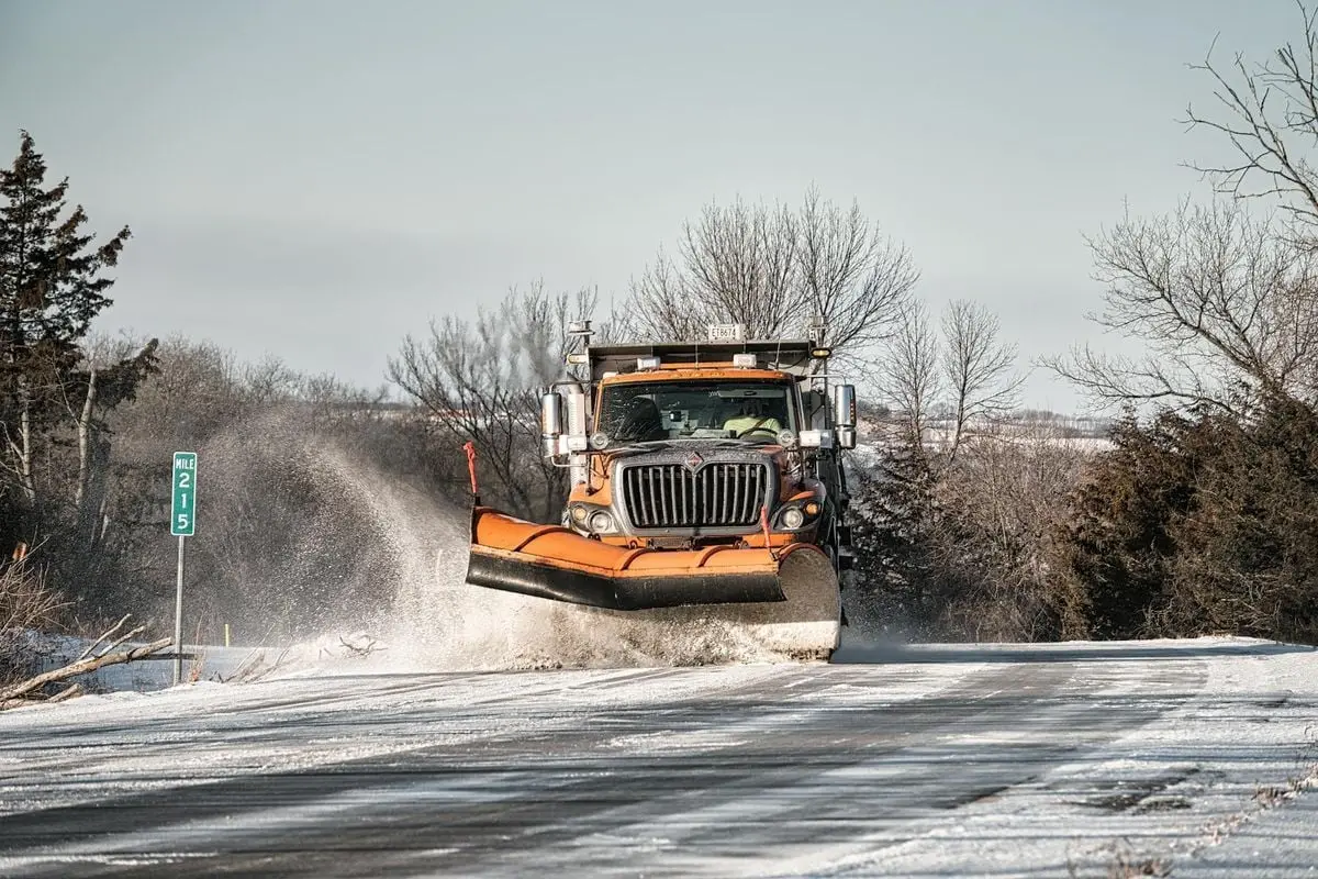 A snowplow clears a snowy road in Wabasha, MN during winter.