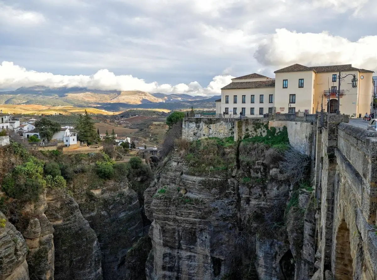 Stunning view of Ronda's cliffside architecture with dramatic landscapes and mountains in Spain.