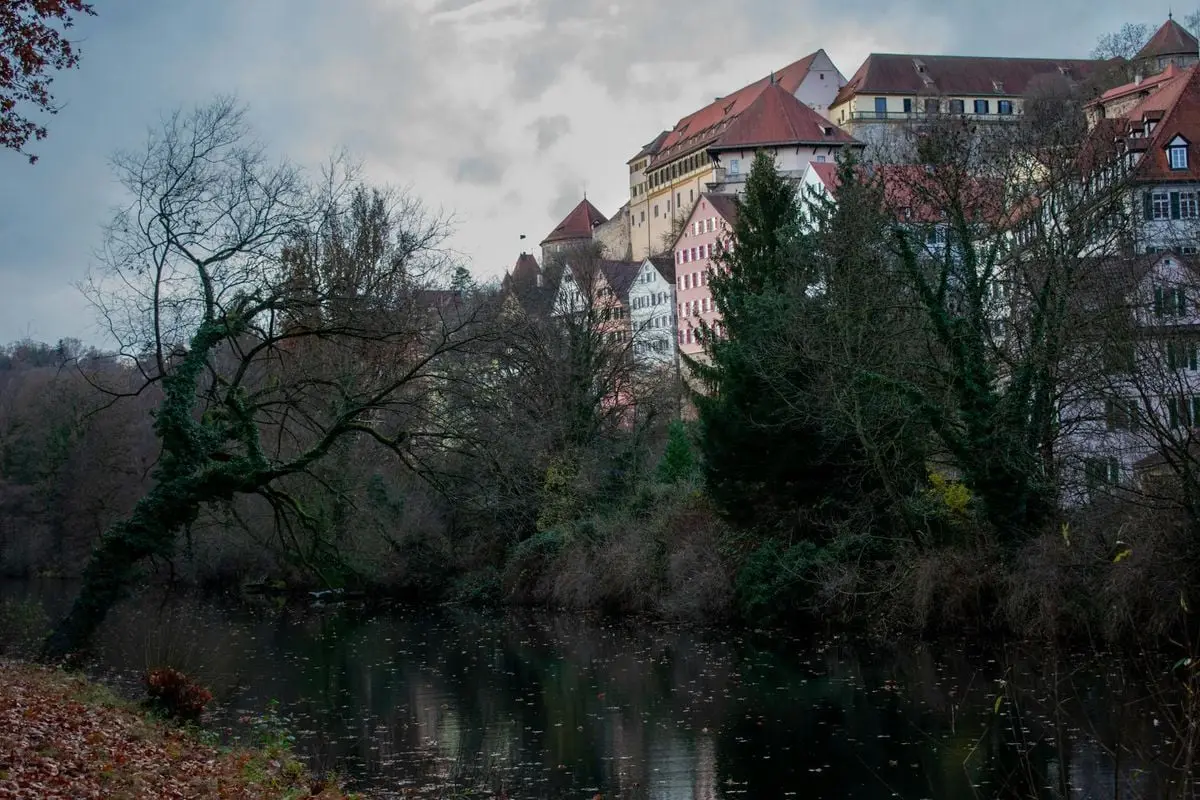 Picturesque view of Tübingen, Germany, with reflections on the river and historic buildings.