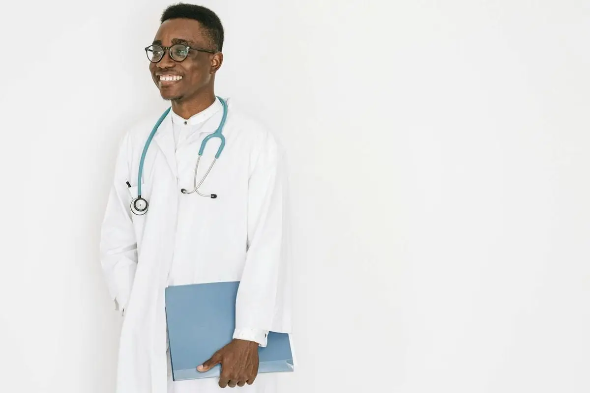 Confident doctor with stethoscope and folder, exuding professionalism and warmth.