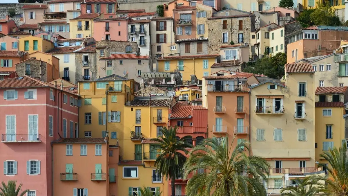 Vibrant residential buildings in a Mediterranean town, showcasing diverse architecture.