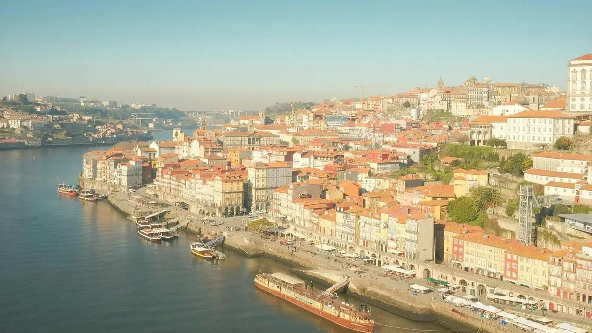 Breathtaking aerial view of Ribeira district along Douro River in Porto, Portugal with colorful architecture.