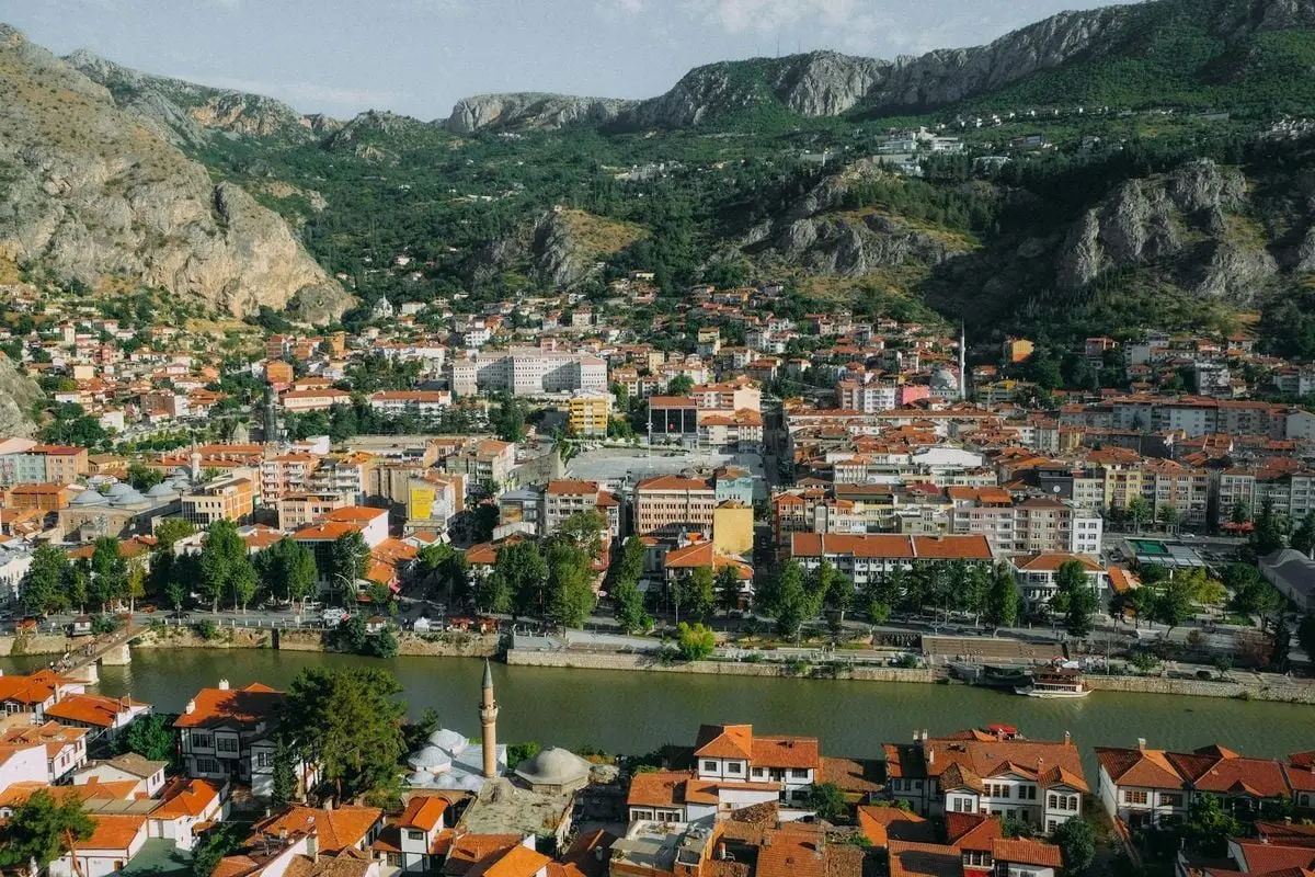 A stunning aerial view of a mountain town with vibrant rooftops and lush scenery.