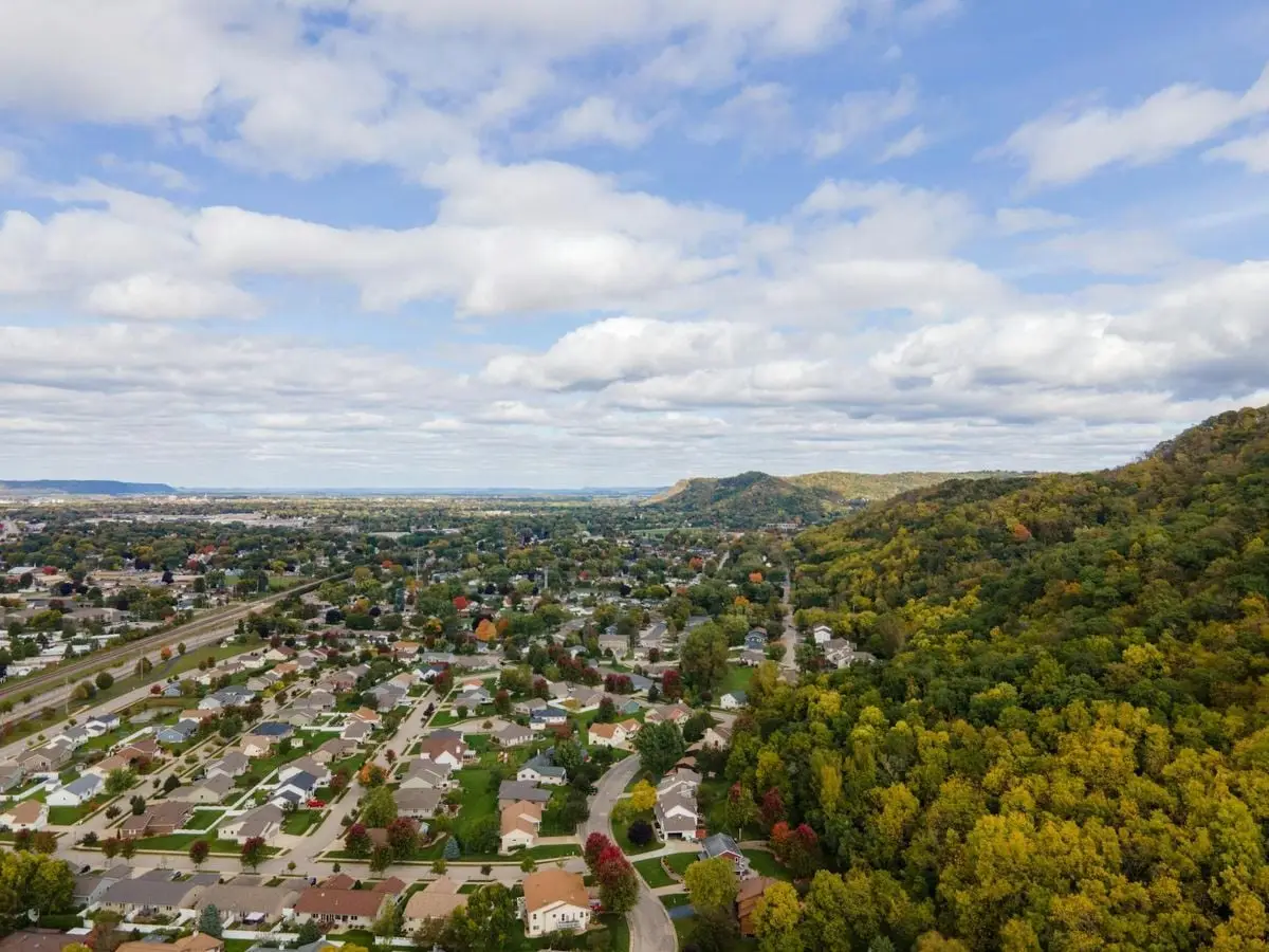 A stunning aerial view of residential neighborhoods beside lush forests in La Crosse, Wisconsin.