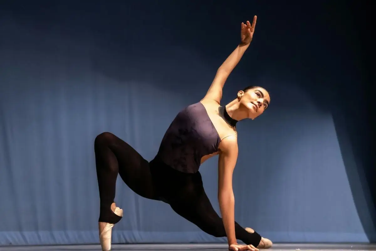 A graceful ballet dancer demonstrates flexibility and poise in a captivating stage performance.