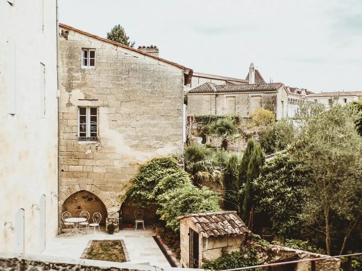 Picturesque view of a quaint courtyard in historic Saint Émilion, France.