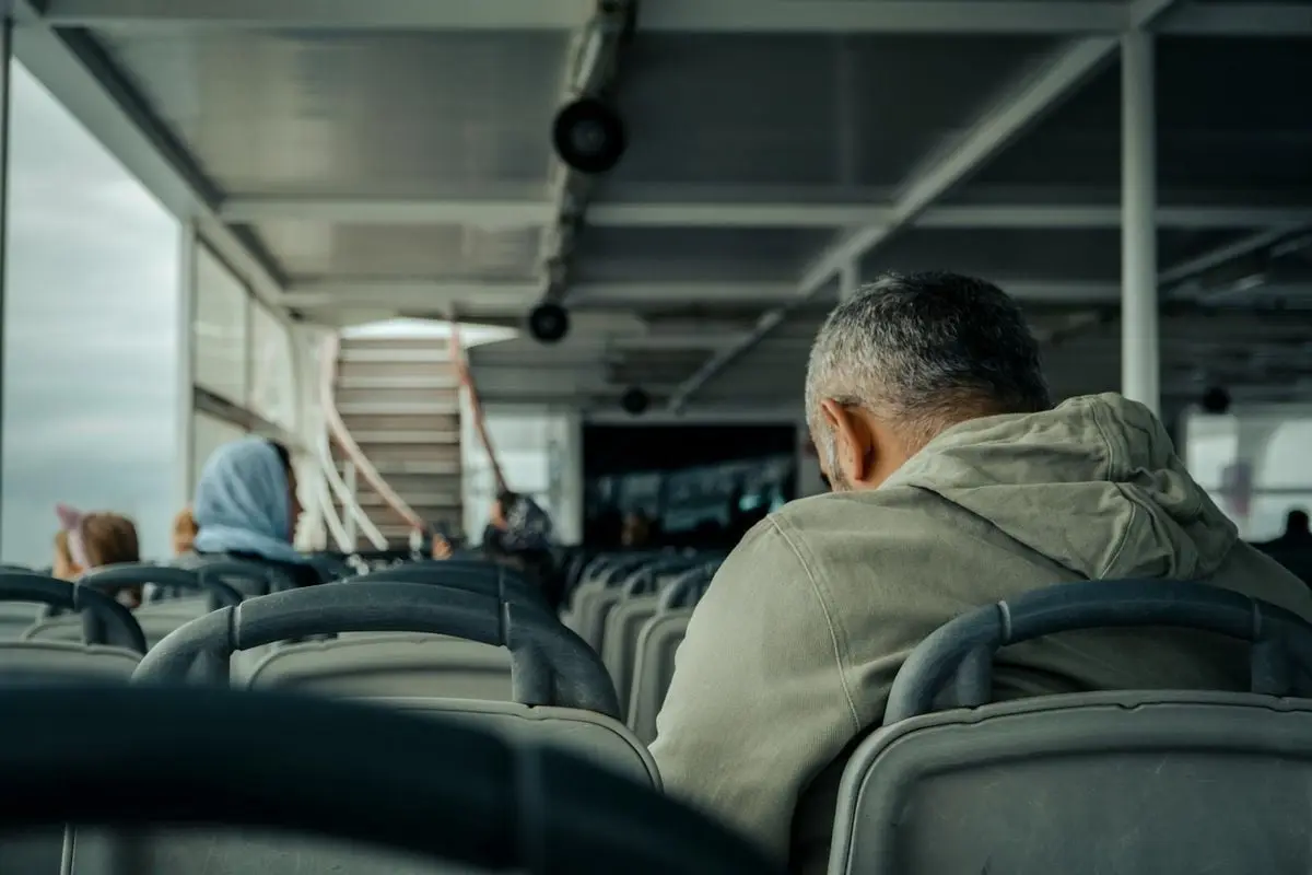 Passengers seated on a quiet ferry. Capturing calm travel atmosphere.