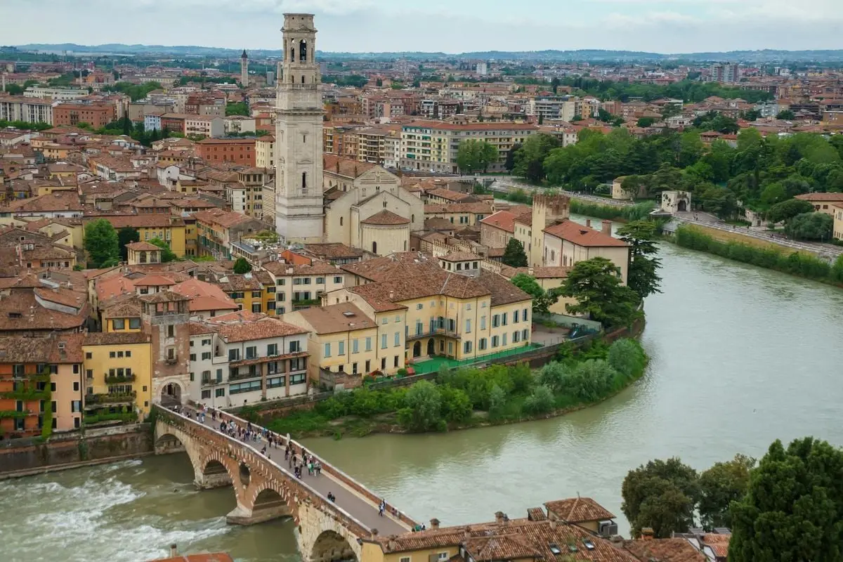 Explore the scenic aerial view of Verona, featuring historic architecture, Adige River, and iconic landmarks.