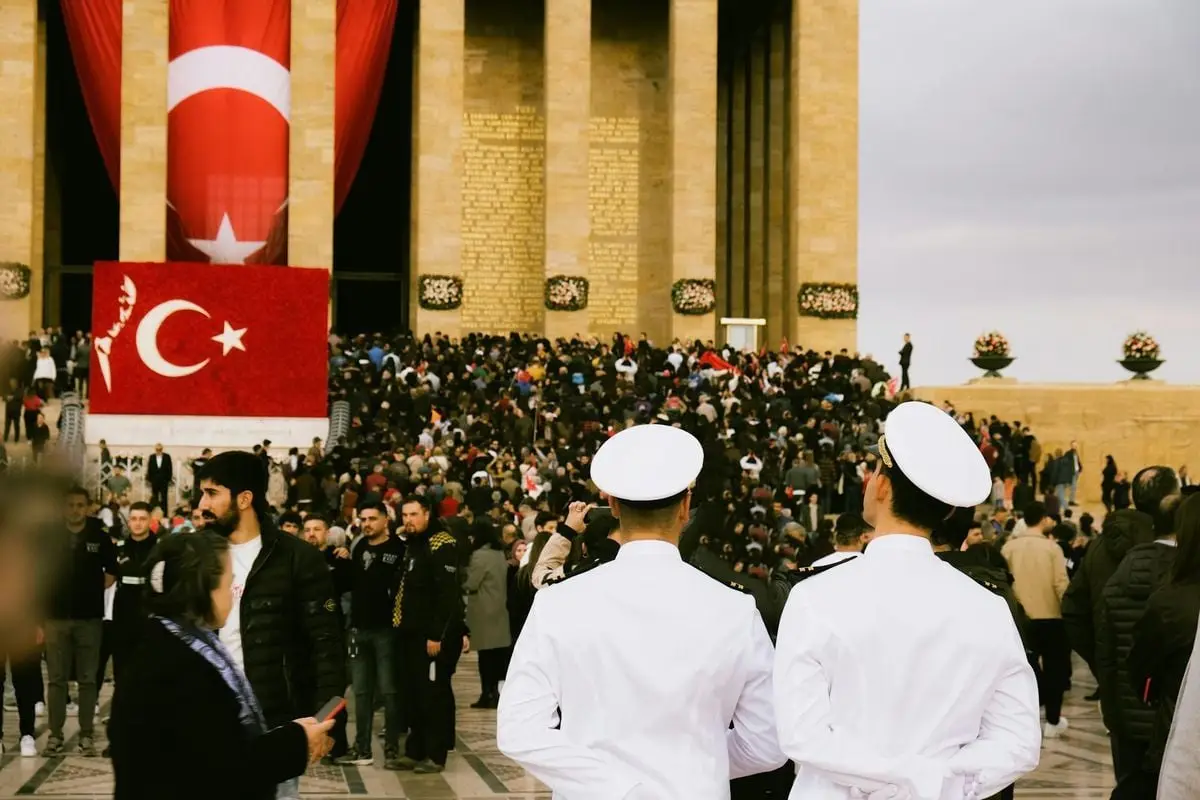 A large crowd gathers at Anıtkabir in Ankara, Turkey, showcasing national pride and cultural heritage.