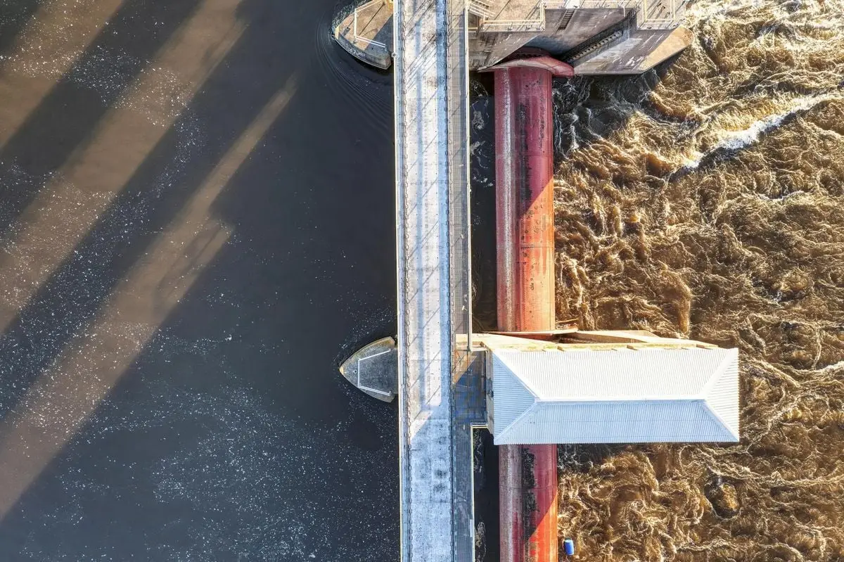 Drone shot capturing water flow at a dam in Minnesota. Ideal for engineering or nature concepts.