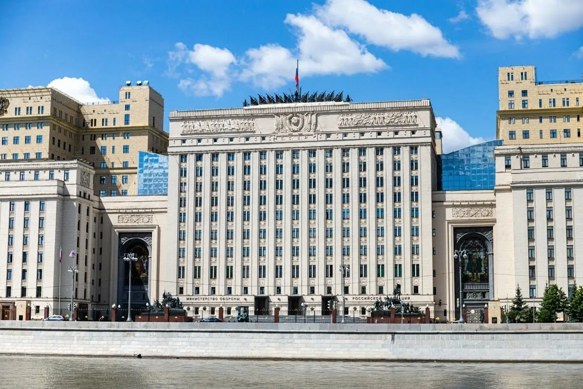 Facade of the Russian Ministry building in Moscow along the river under a clear sky.