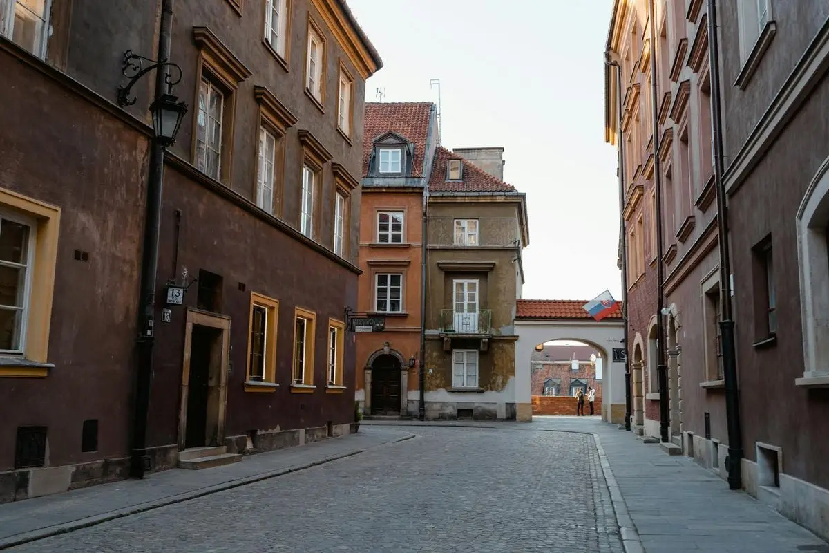 Empty European cobblestone street with historic buildings and vibrant facades.