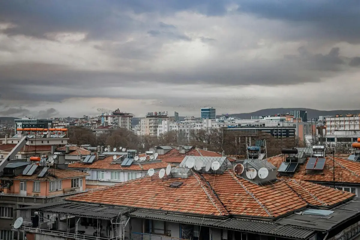 An expansive view over Gaziantep's urban skyline with cloudy skies and traditional rooftops.