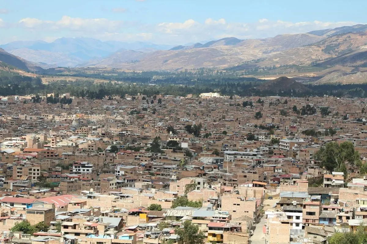 Aerial panorama of Cajamarca city, Peru, showcasing urban landscape against mountain backdrop.