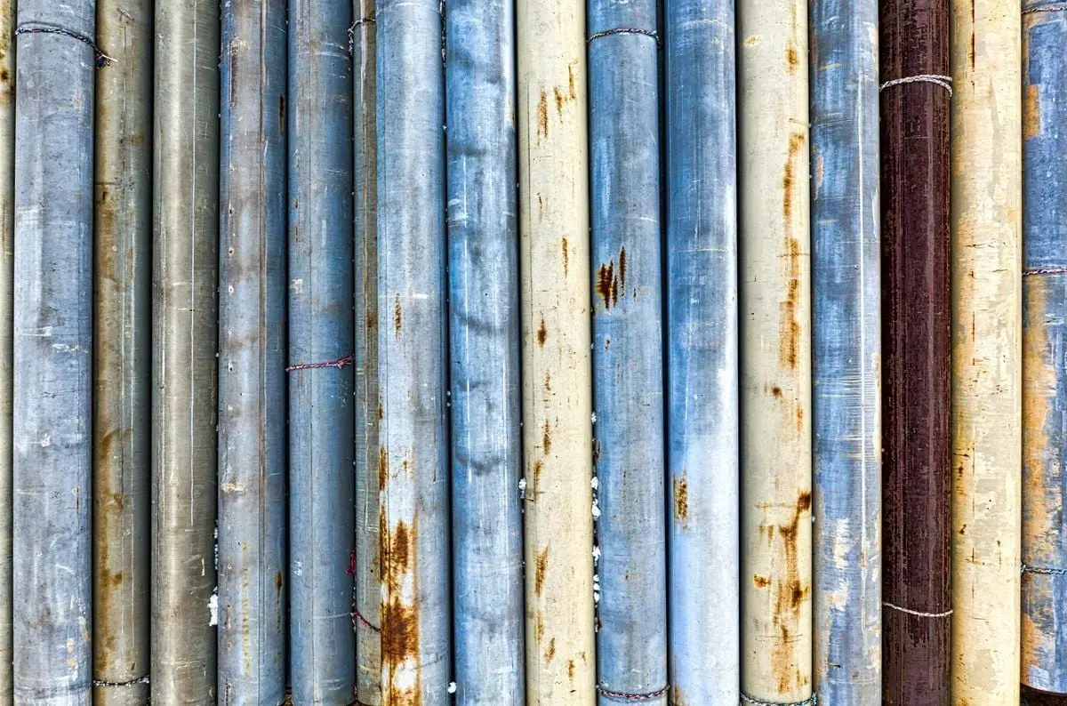 Abstract close-up of weathered and rusty metal pipes showcasing texture and decay.