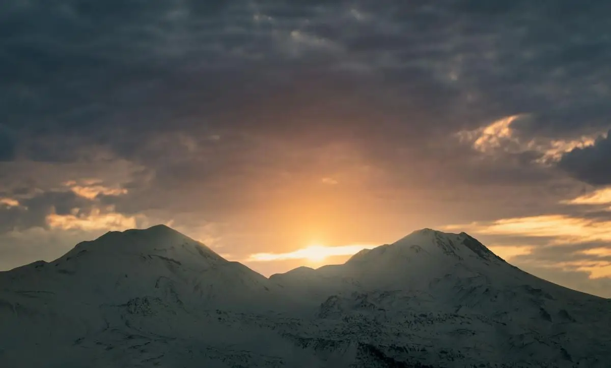 A breathtaking view of sunset over snow-capped Hasan Dağı in winter, Aksaray, Turkey.
