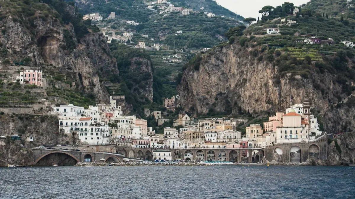 Charming Italian town nestled among cliffs by the sea, offering stunning architecture and scenery.