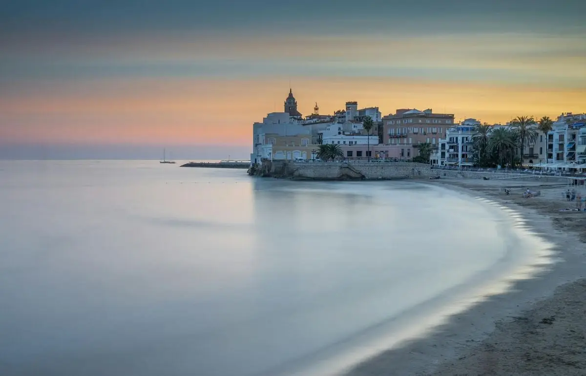 Beautiful twilight view of Sitges beach and cityscape in Catalonia, Spain.