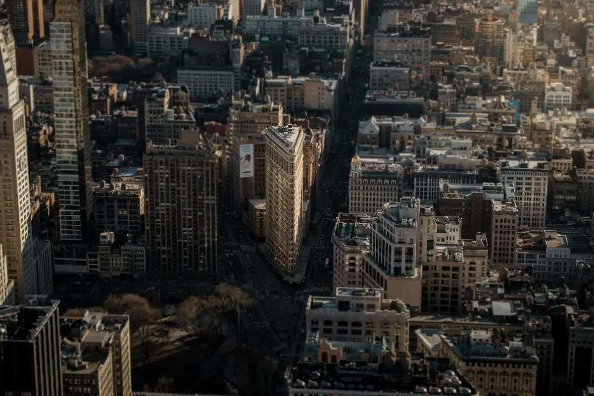 A stunning aerial view highlighting the Flatiron Building amidst the bustling cityscape of New York City.