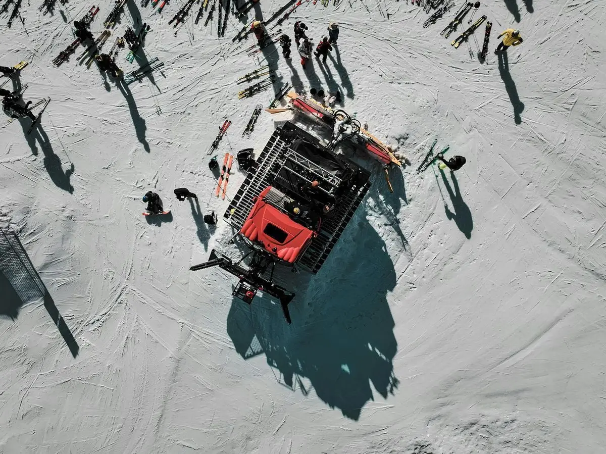 High-angle shot of skiers and a snowcat on a snowy slope at Hinterstoder, Austria.