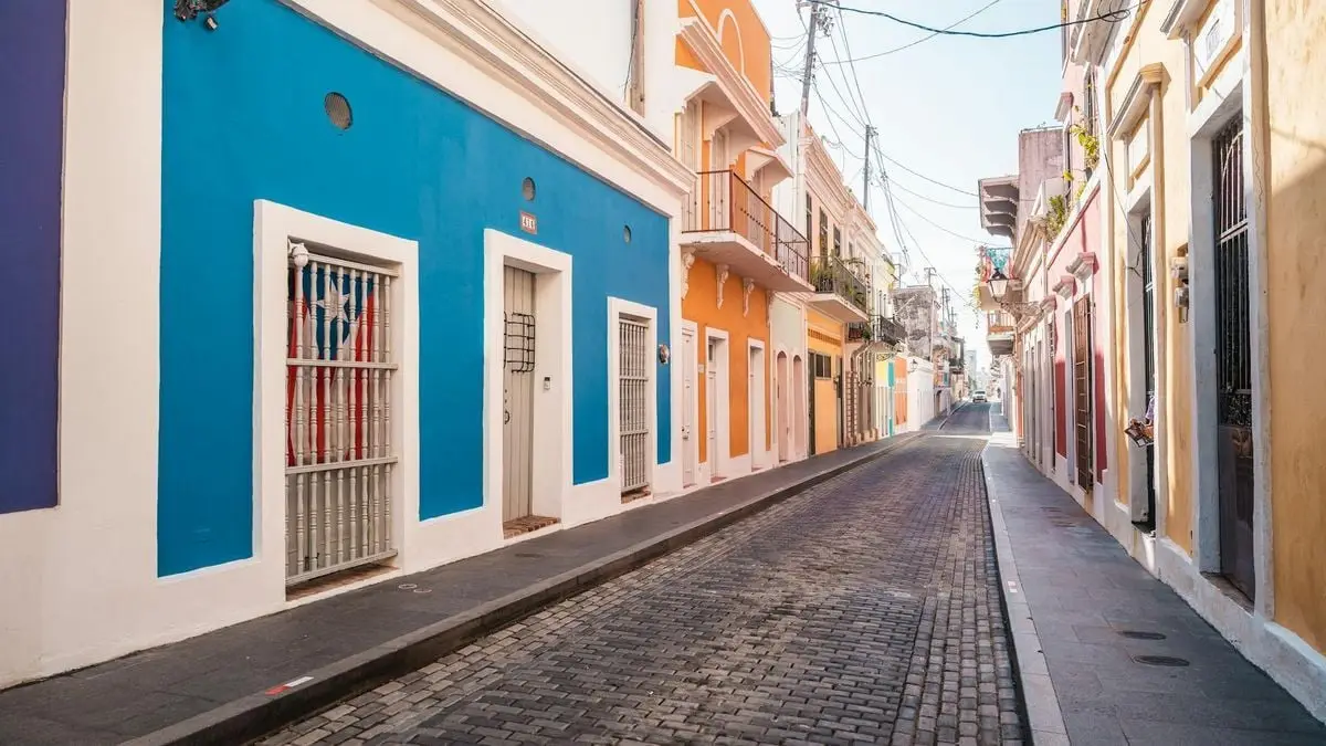 A picturesque street view showcasing colorful buildings in a historic old town alley during the day.