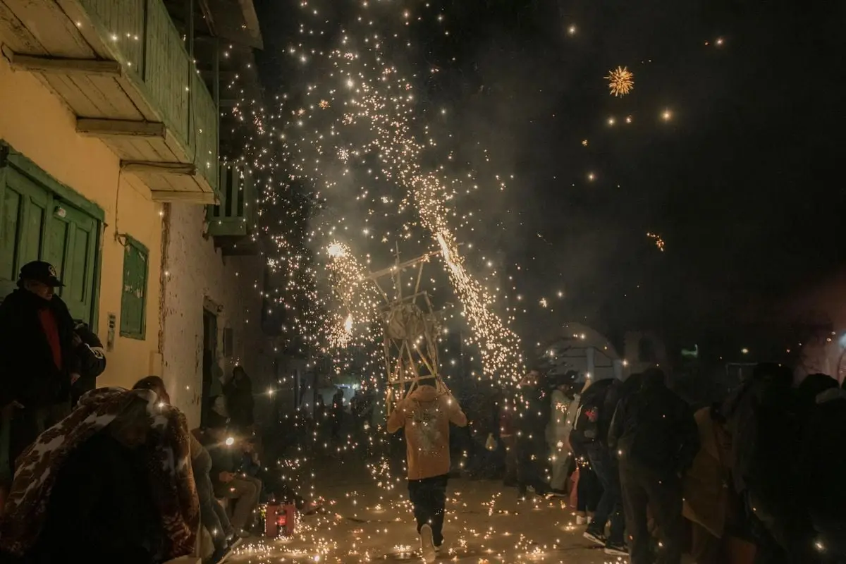 A vibrant night festival in Huancavelica, Peru with fireworks and traditional celebrations.