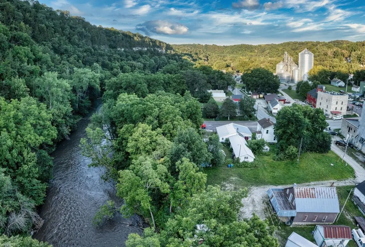 A picturesque aerial view of Lanesboro, MN, showcasing lush greenery and a flowing river.