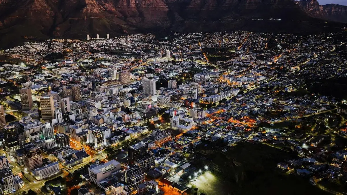 A stunning aerial view of Cape Town city lights at night against Table Mountain.
