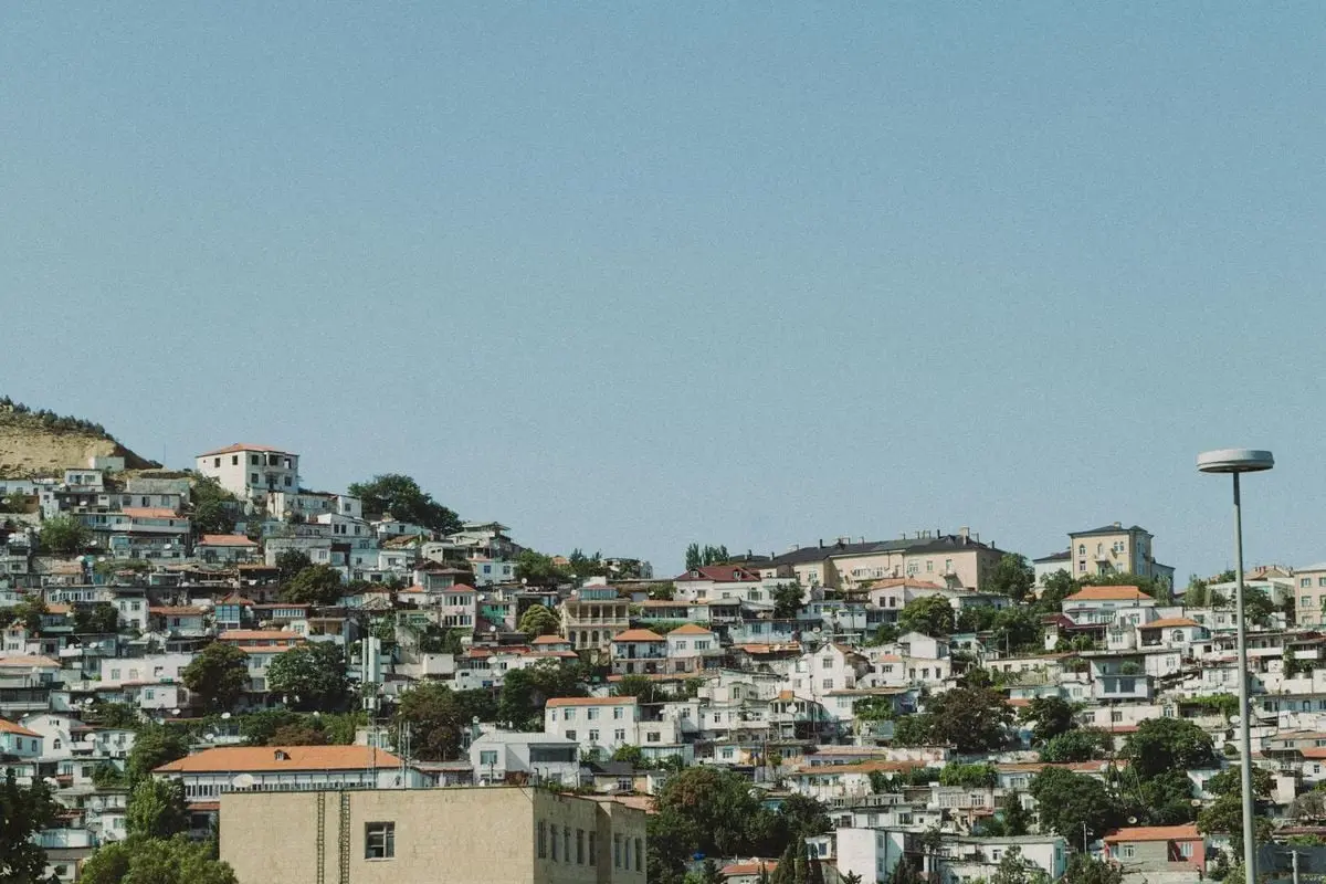Charming urban hillside view with clustered houses under a clear blue sky.