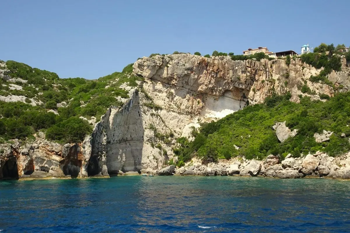 Breathtaking view of a rocky coastline with azure waters under a clear blue sky.