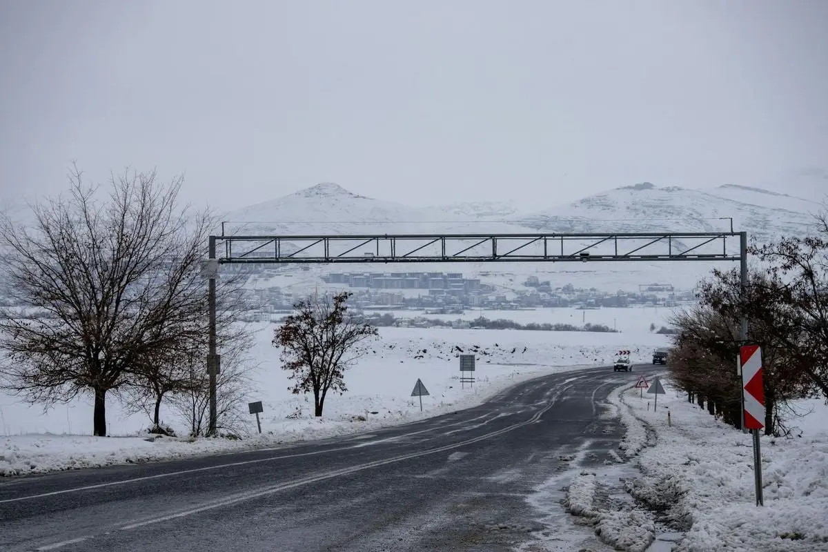 Snow-covered road leading to Palu in a serene winter landscape in Elazığ, Türkiye.