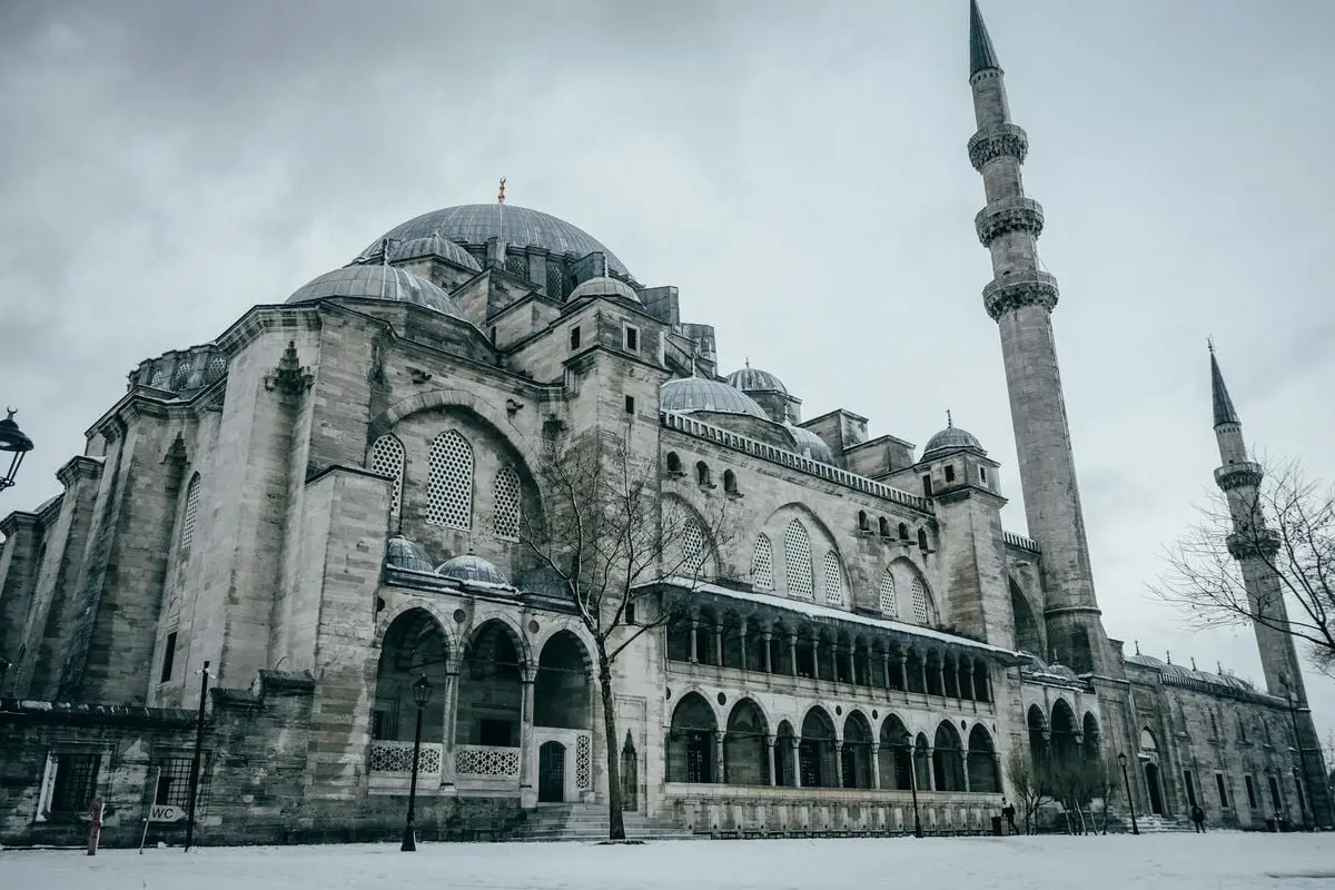 Explore the grandeur of Süleymaniye Mosque in snowy Istanbul, capturing an iconic landmark in winter.