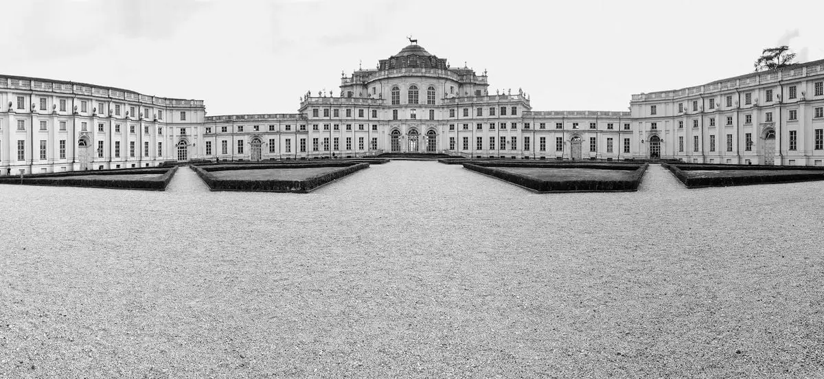 Black-and-white panoramic view of the majestic Stupinigi Palace in Torino, Italy.