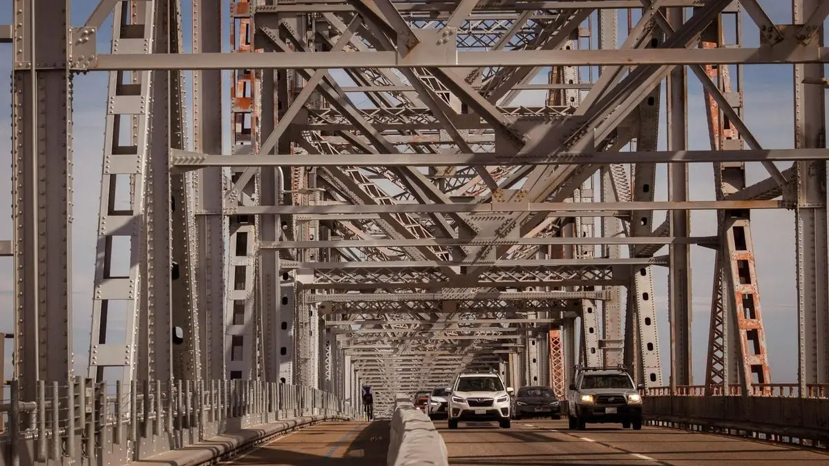 View of a steel bridge filled with cars, showcasing urban infrastructure.