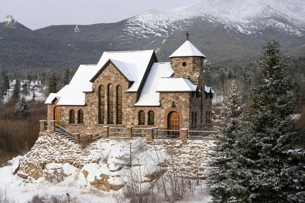 Beautiful stone chapel in a snowy mountain setting in Allenspark, Colorado.