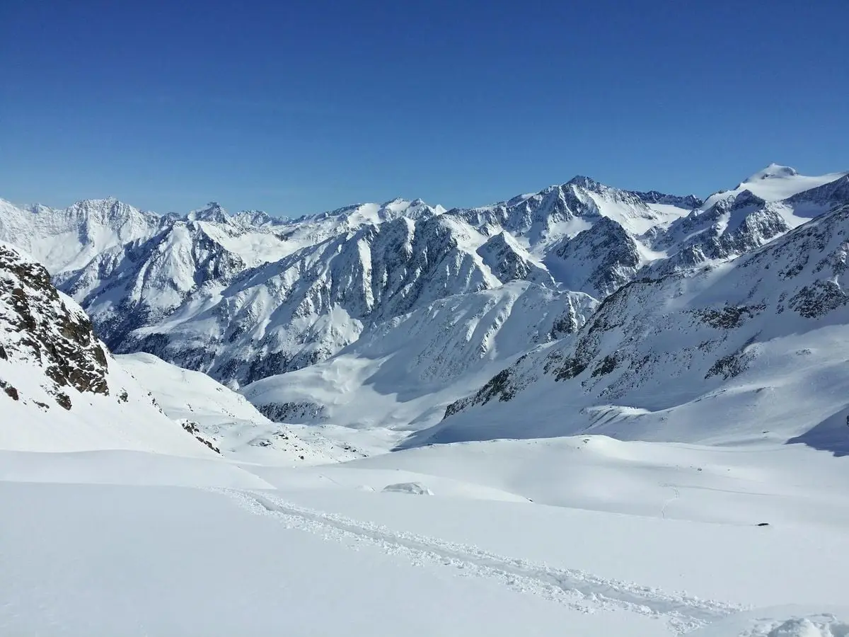 Majestic snowy mountains under a clear sky in Schwaz, Tirol, Austria.