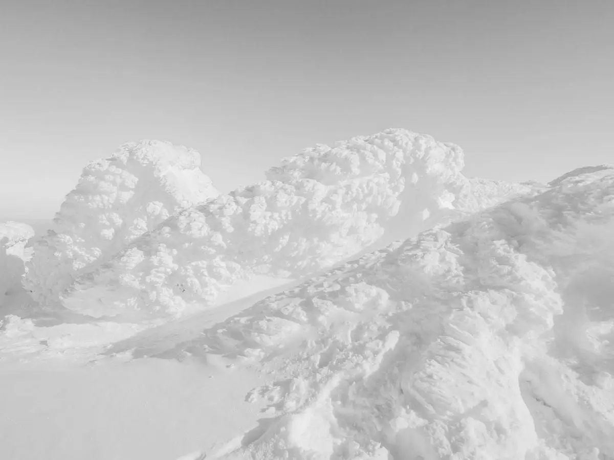 Stunning monochrome view of snow-covered mountain peaks in Bulgaria's winter landscape.