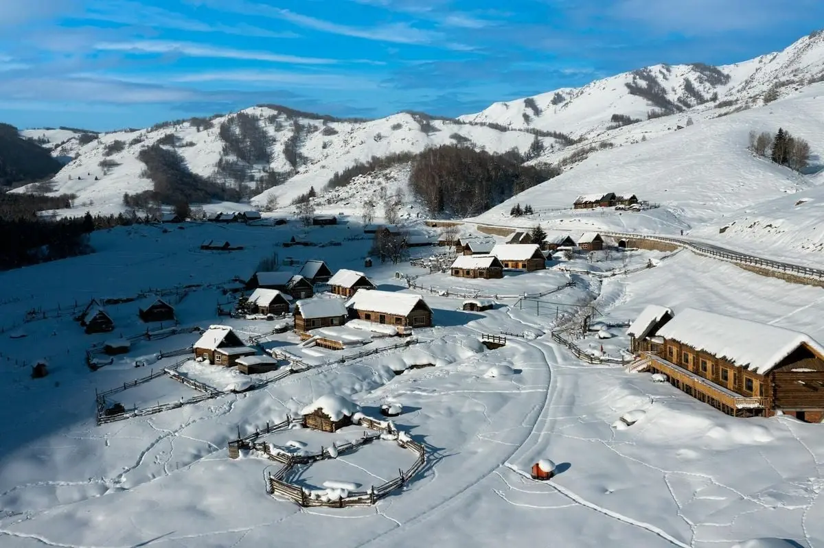 A winter aerial view of a snow-covered village in Altay Prefecture, Xinjiang, China.