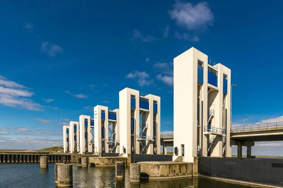 View of contemporary hydraulic gates at a waterfront on a sunny day, showcasing modern engineering.