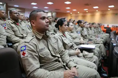 Brazilian firefighters attentively participate in a strategic training session.