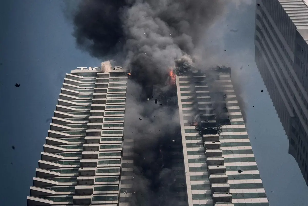 Intense blaze with thick smoke engulfing Tiger Tower in Dubai, UAE.