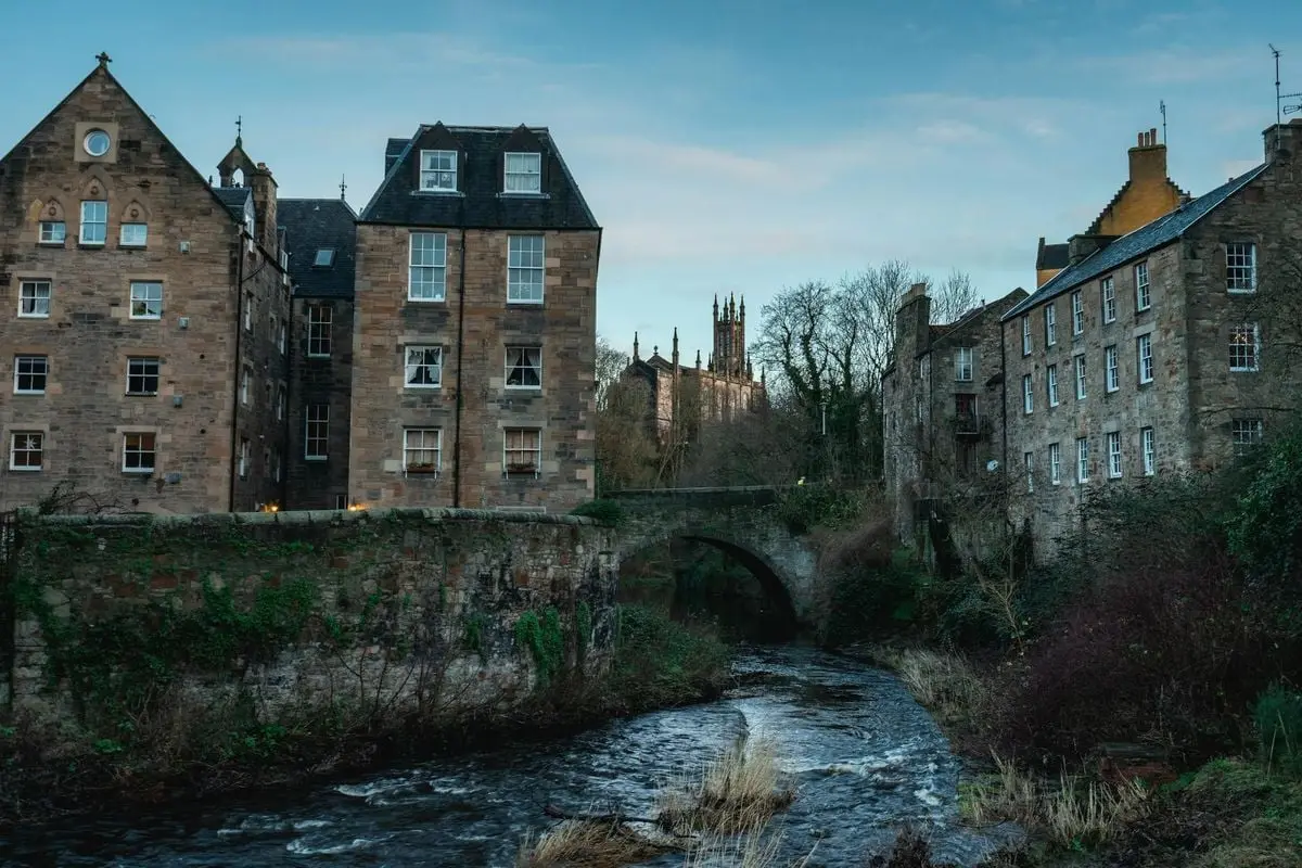 Explore the scenic Gothic architecture alongside the Water of Leith in Edinburgh, Scotland during daytime.