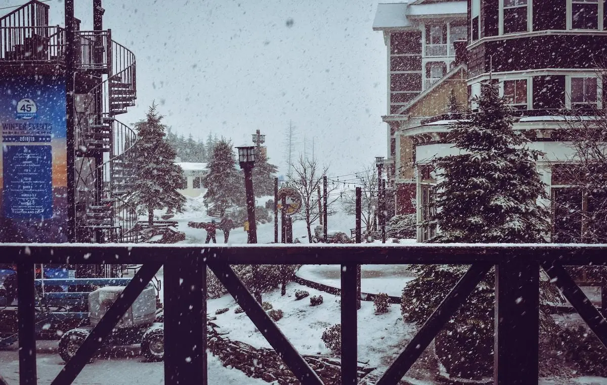 Captivating winter cityscape with snowy streets, buildings, and trees.