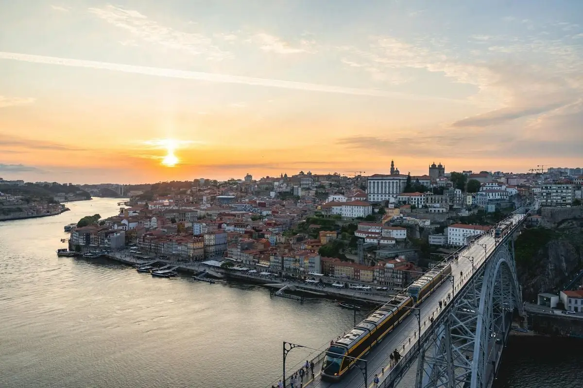 Captivating sunset over Porto with Dom Luís I Bridge and the Douro River in view.
